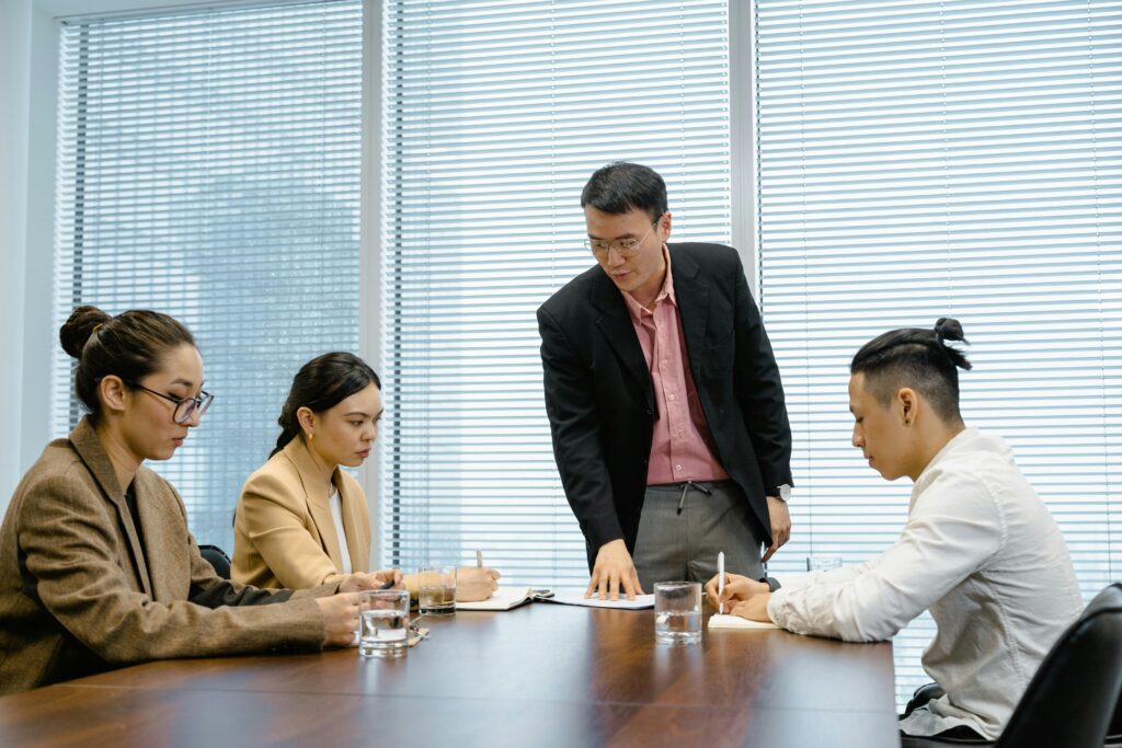 Business leader directing team members at boardroom meeting