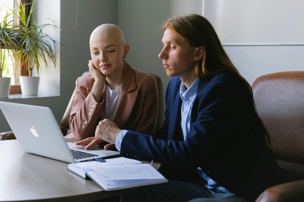 Two business co-founders working together on a laptop, focused and aligned on their next growth phase