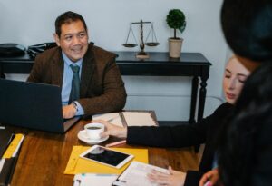 Diverse business professionals in a meeting with scales of justice in the background – representing structured decision-making and legal governance