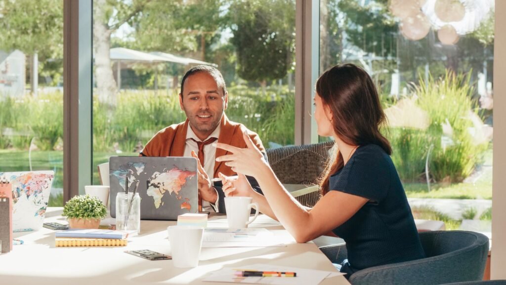 Two business partners in an energised conversation, reflecting the excitement of the Formation and euphoria stage