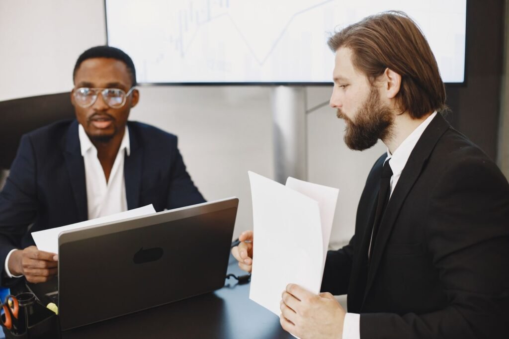 Two cofounders in a serious discussion as they review business documents