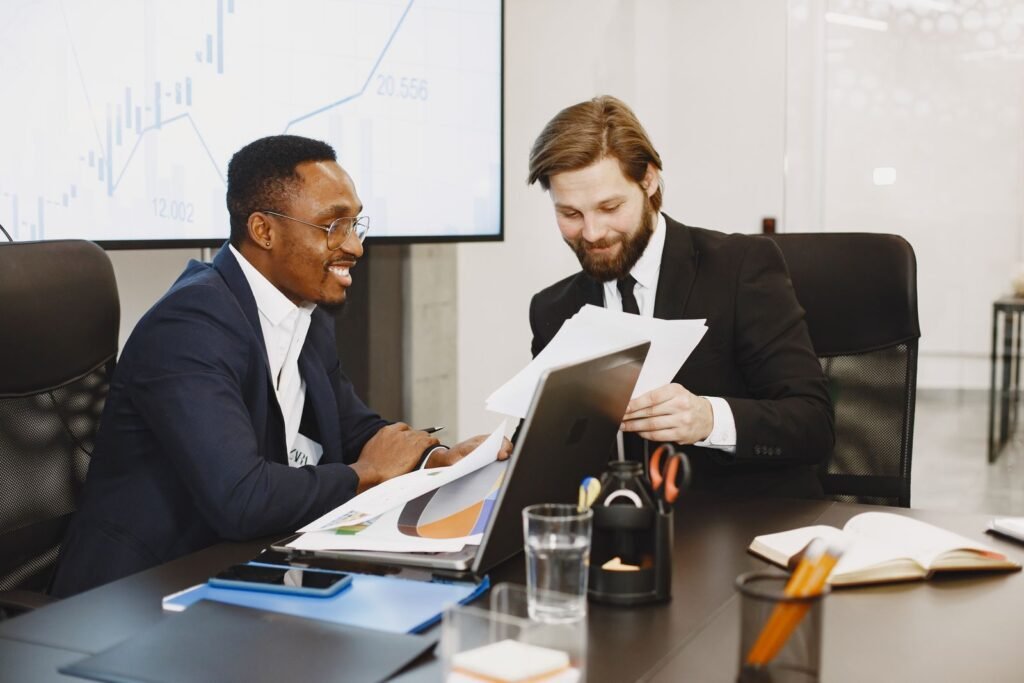Two cofounders reviewing growth plans together after a successful funding round
