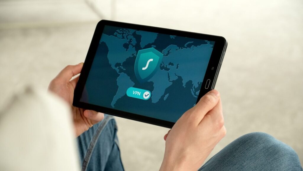 Person holding a tablet displaying a VPN shield, representing secure and confidential AI