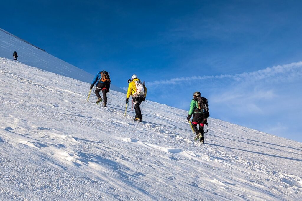 Four mountaineers ascending a snowy slope, symbolising co-founders guided through difficult terrain